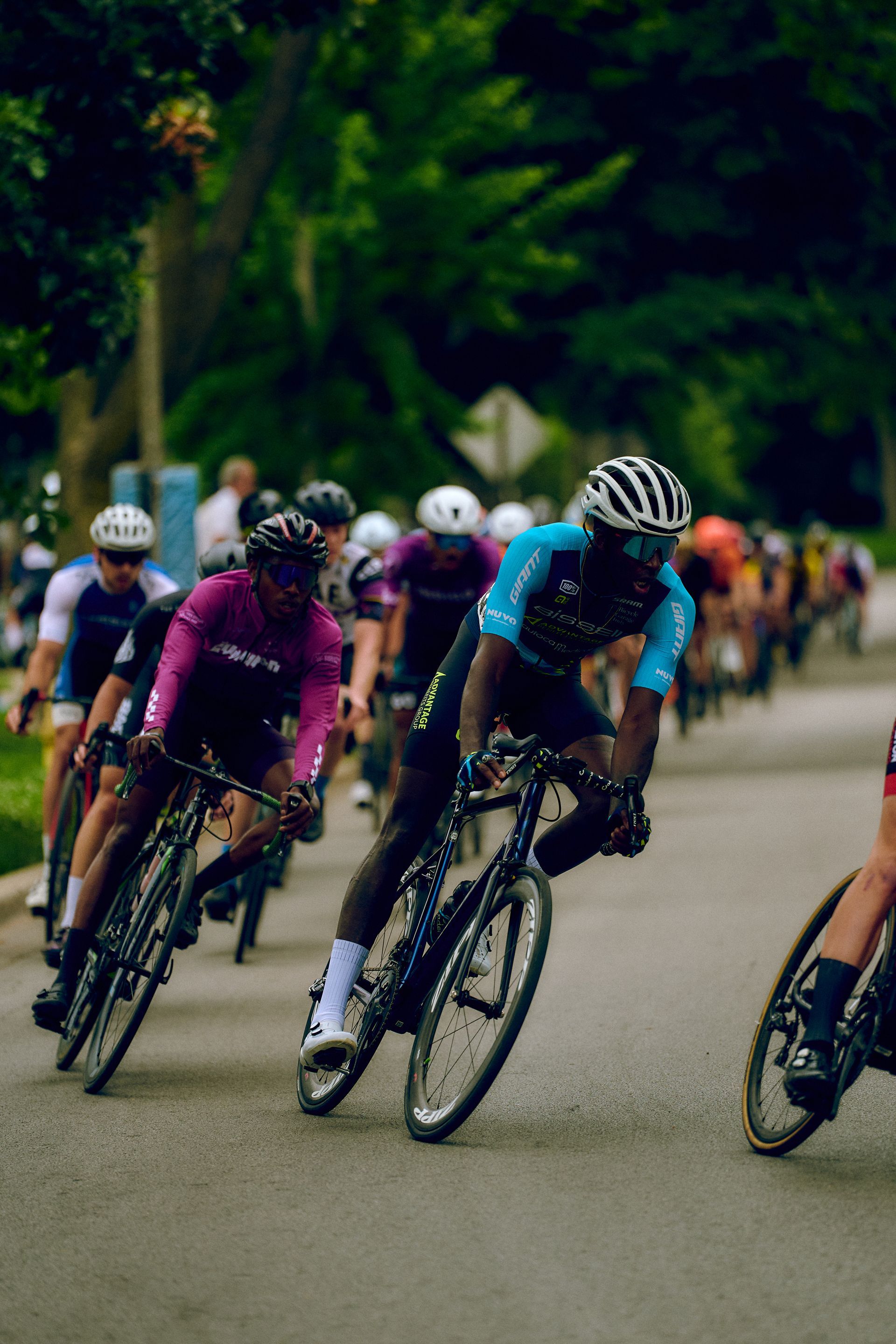 A group of people are riding bicycles down a road.