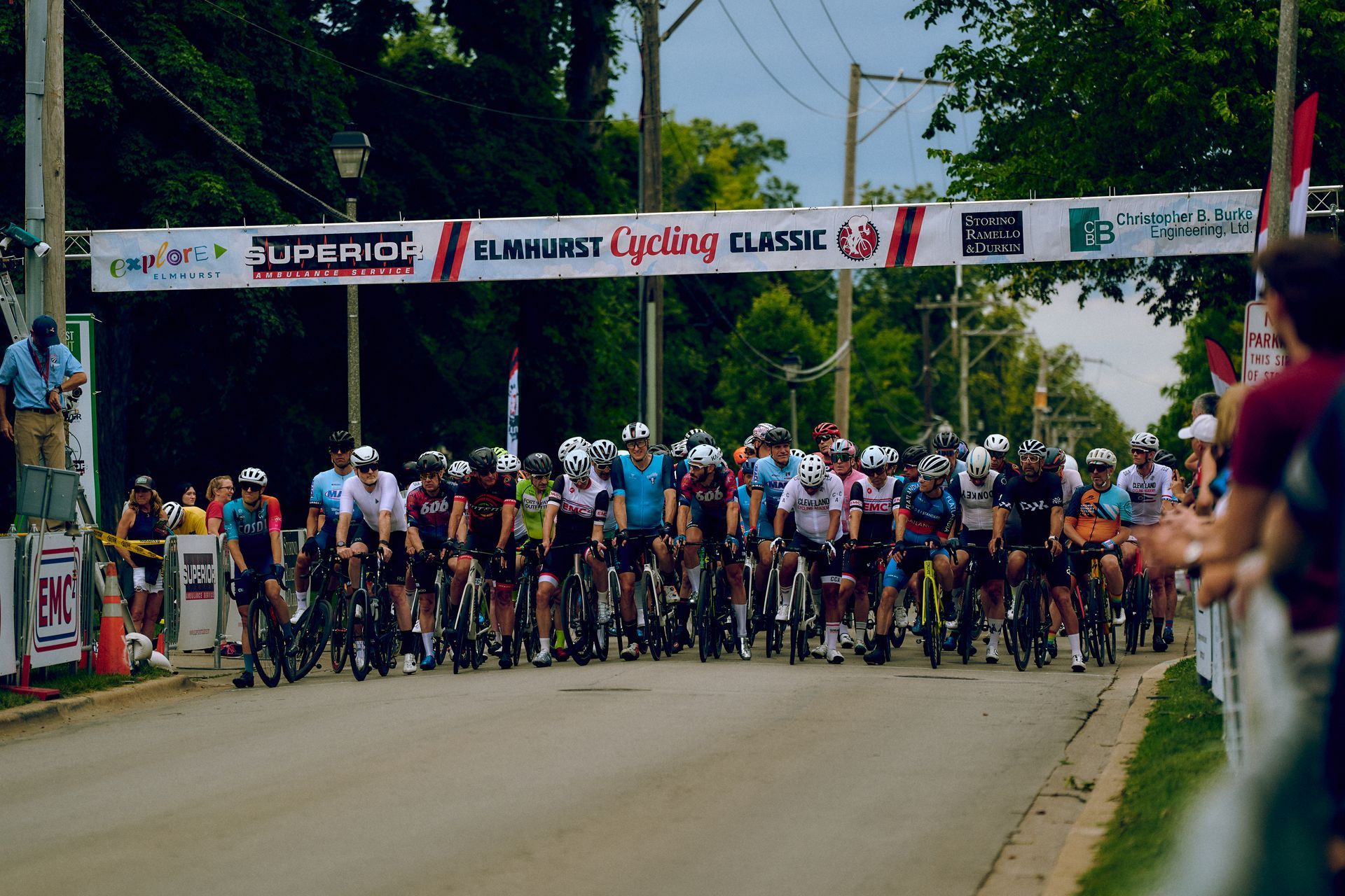 A group of cyclists are lined up at the start of a cycling race