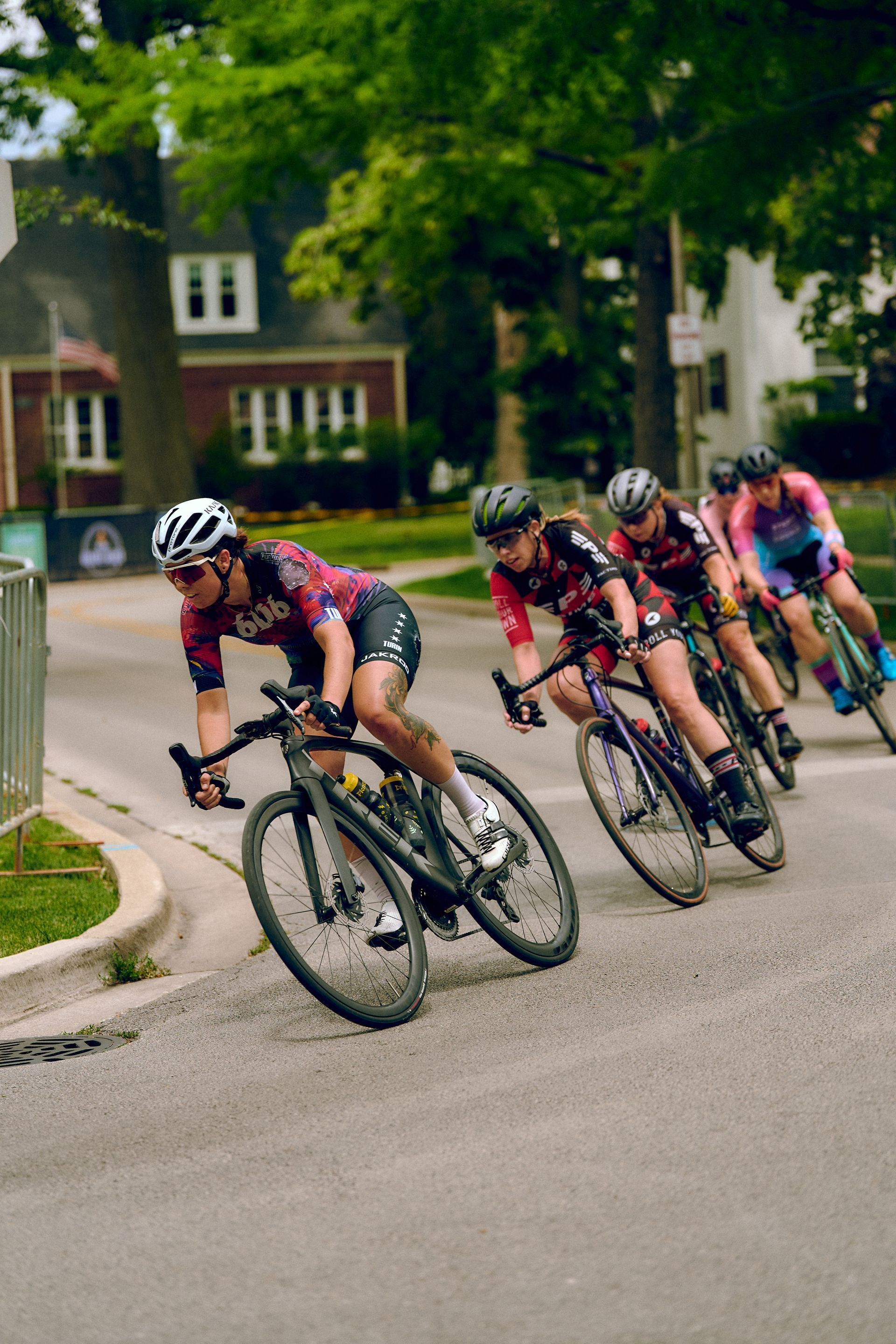 A group of people are riding bicycles down a street.