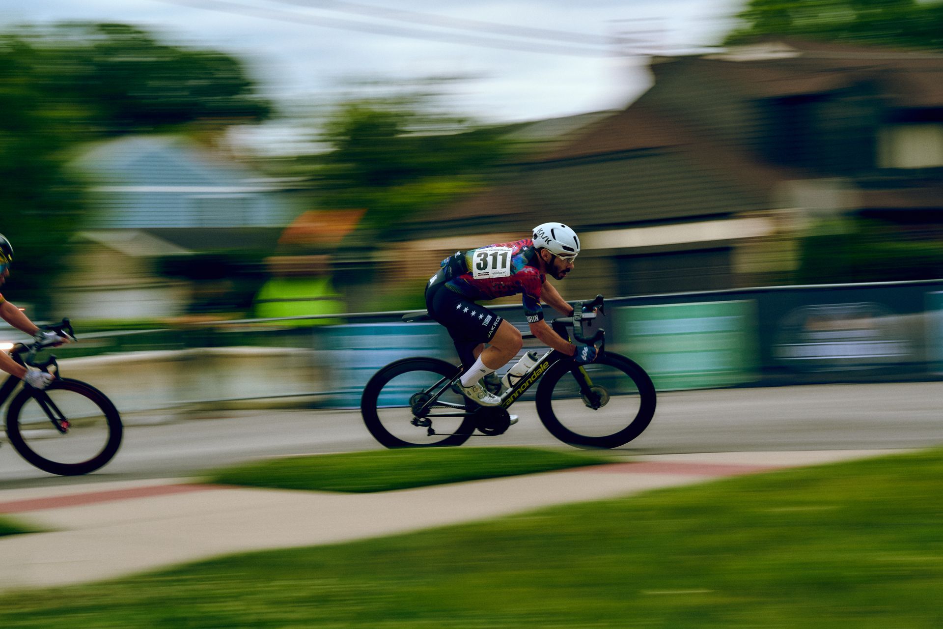 A man is riding a bike down a street.