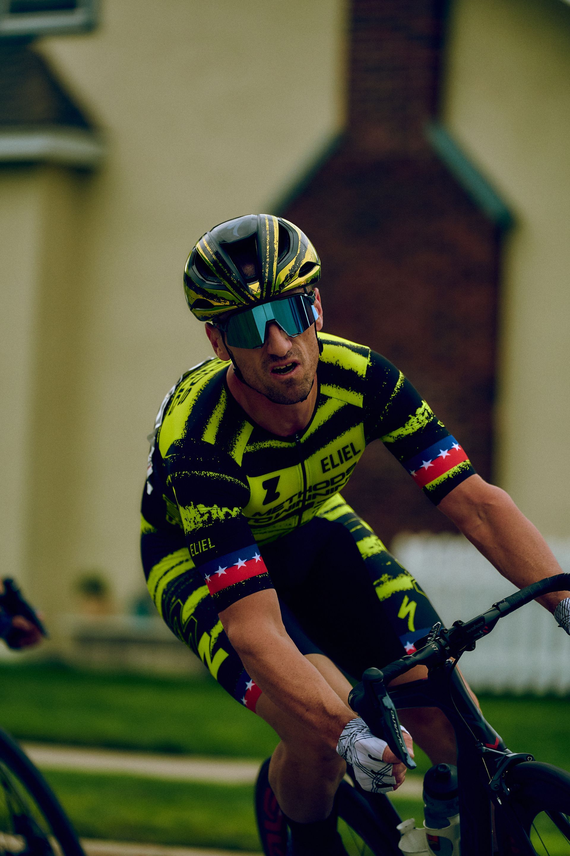 A man wearing a helmet and goggles is riding a bike