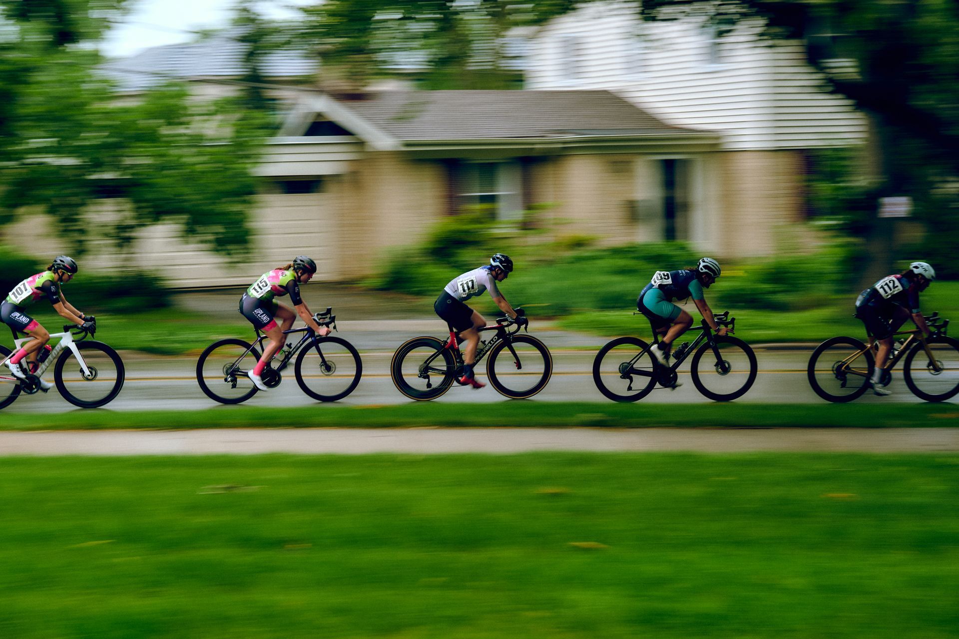 A group of people are riding bicycles down a street.