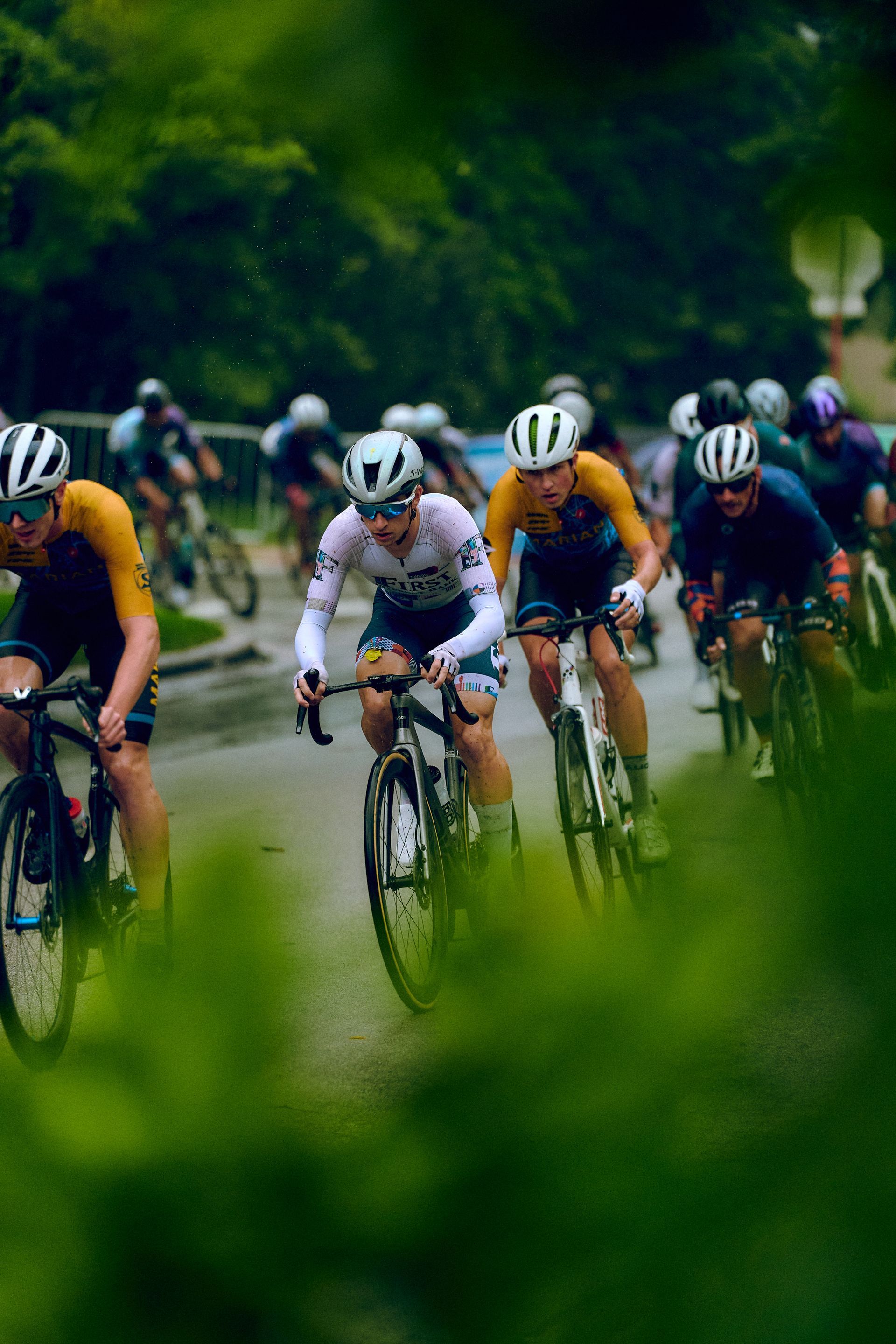A group of people are riding bicycles down a road.