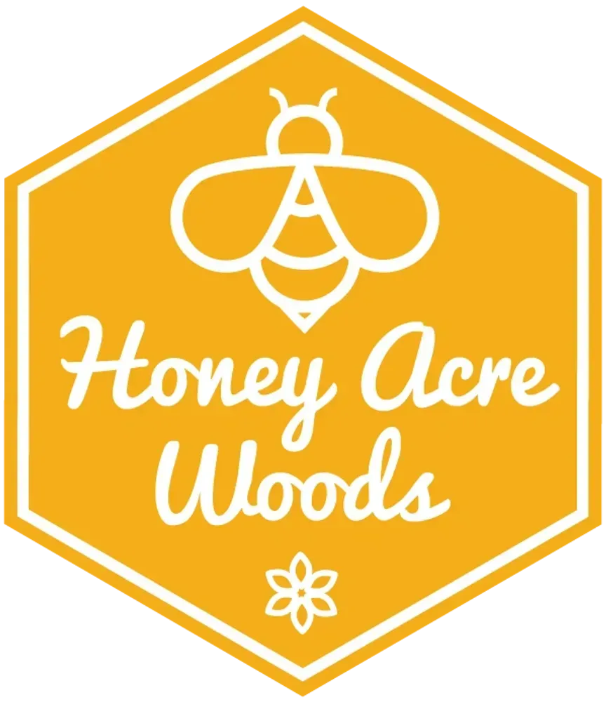 A logo for honey acre woods with a bee and a flower