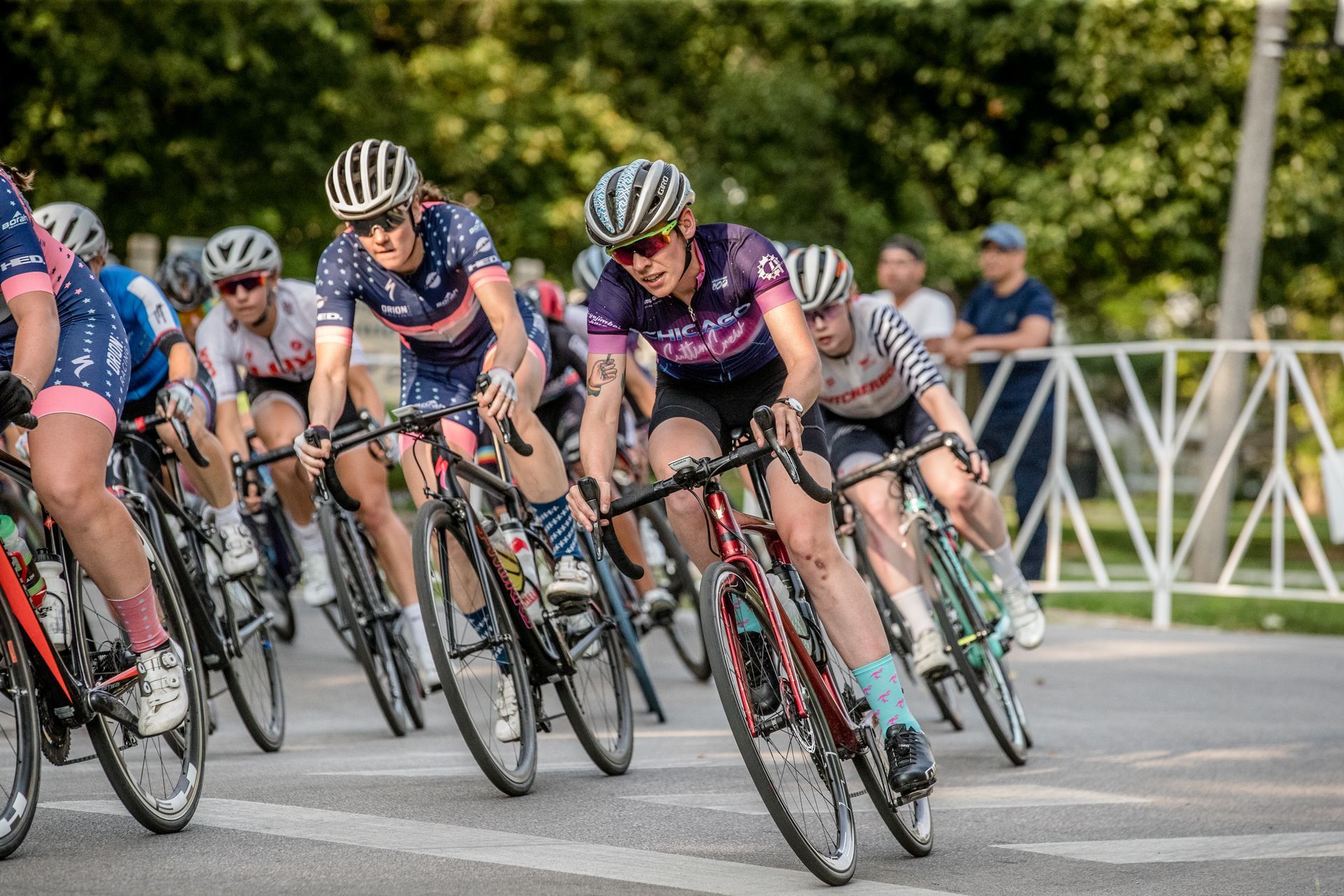 A group of people are riding bicycles down a street.