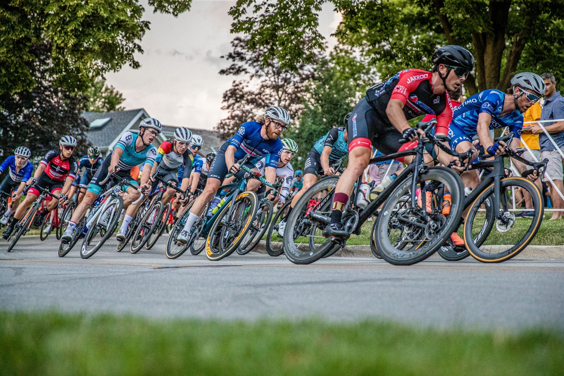 A group of people are riding bicycles down a road.