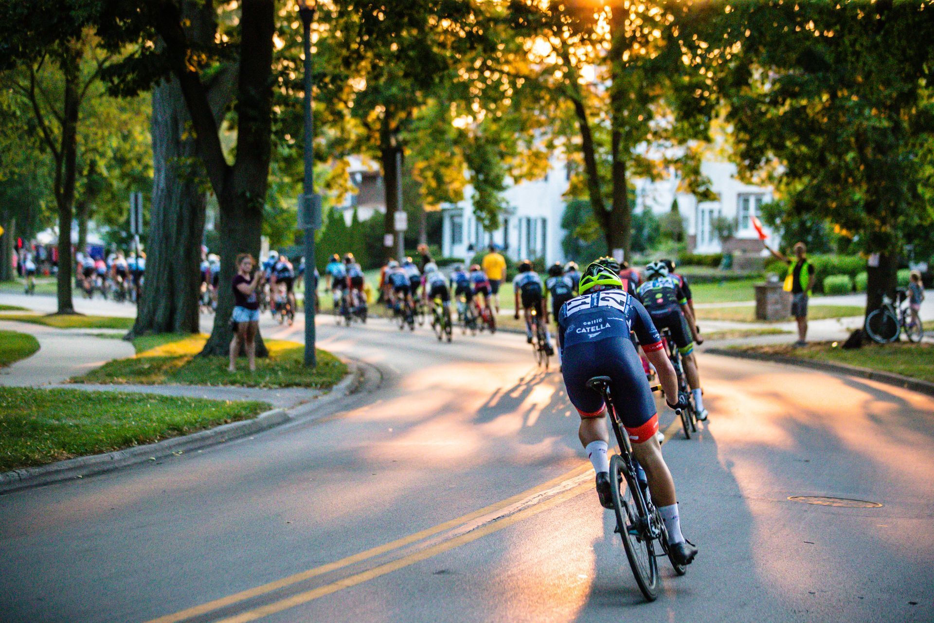 A group of people are riding bicycles down a street.