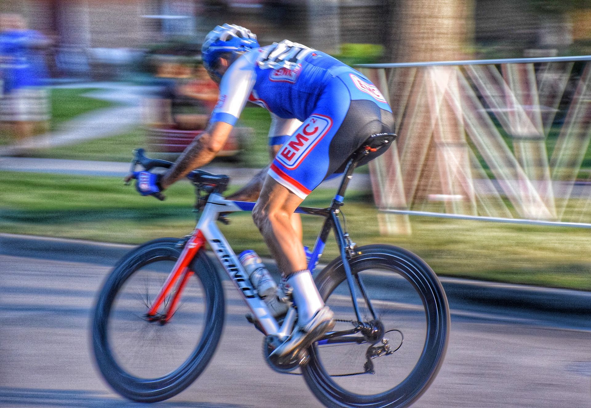 A man is riding a bicycle down a street.