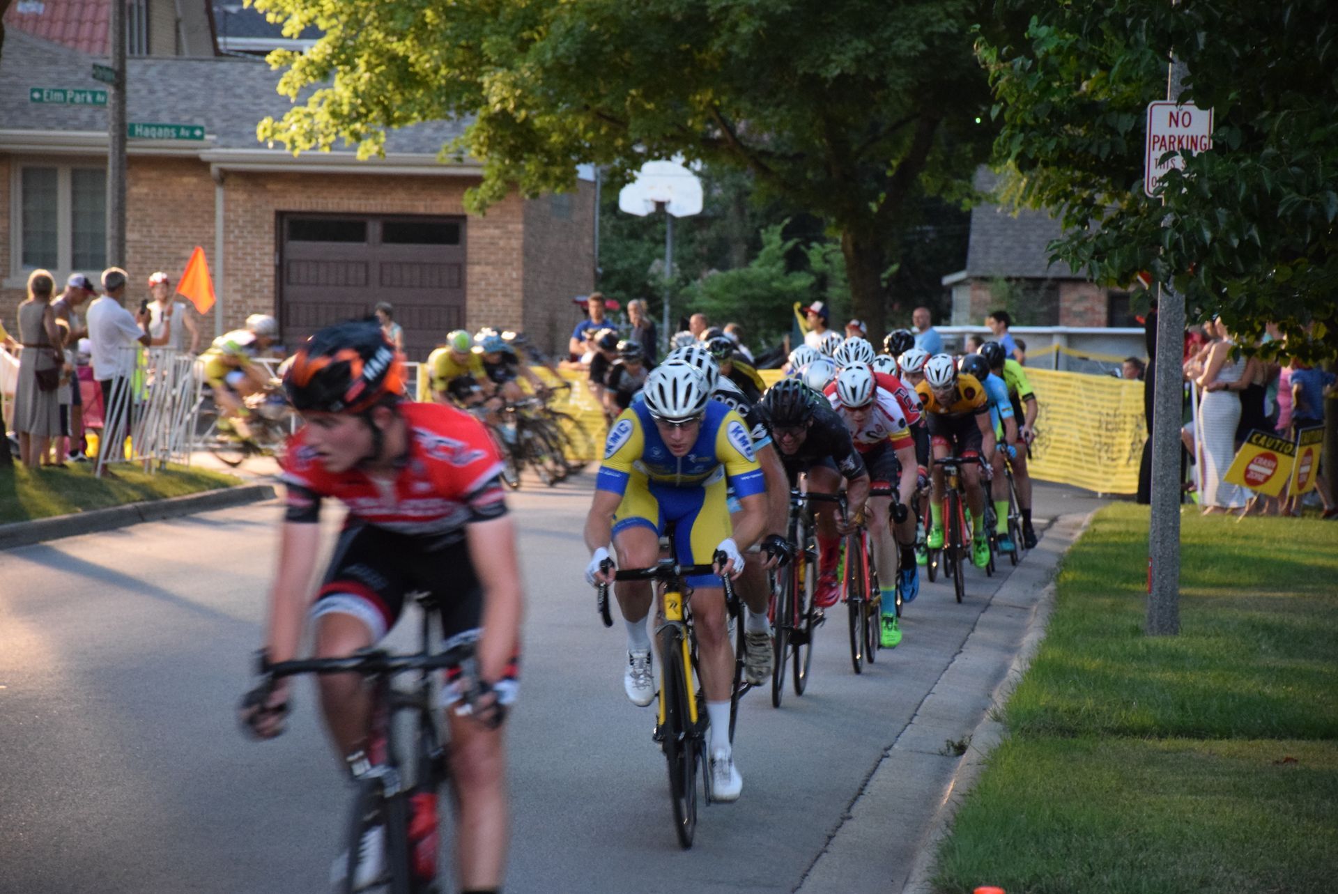 A group of cyclists are riding down a street.