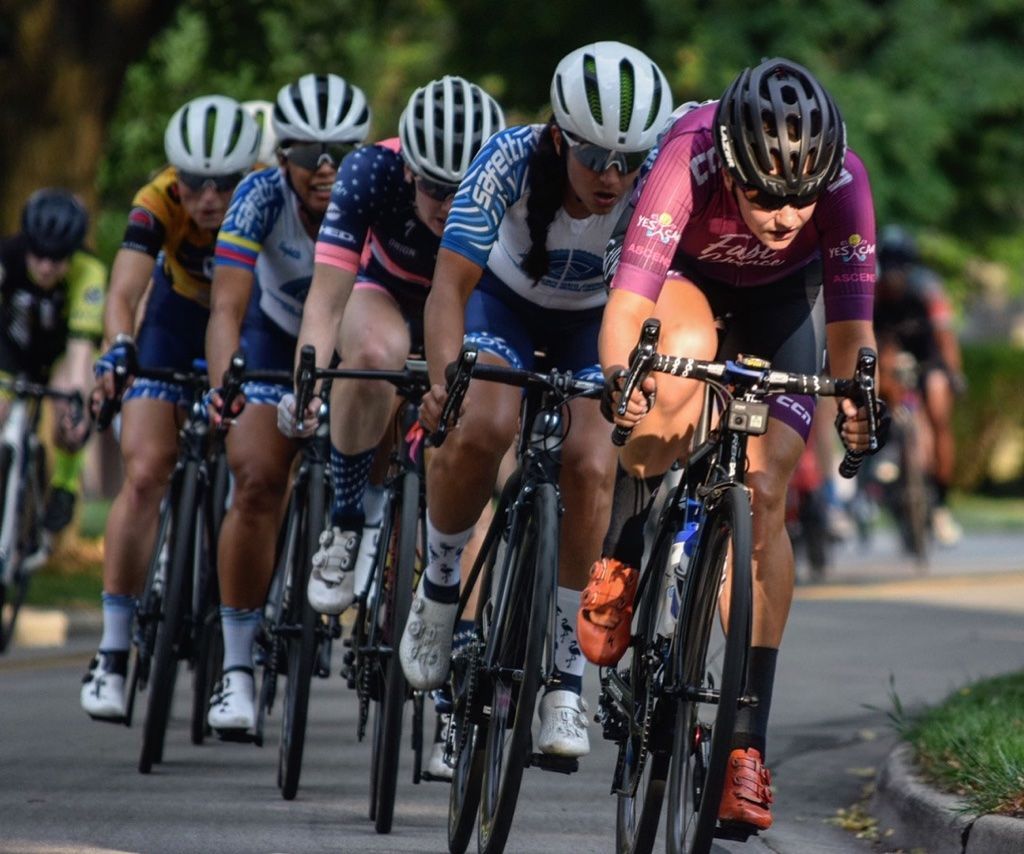 A group of people are riding bicycles down a road.