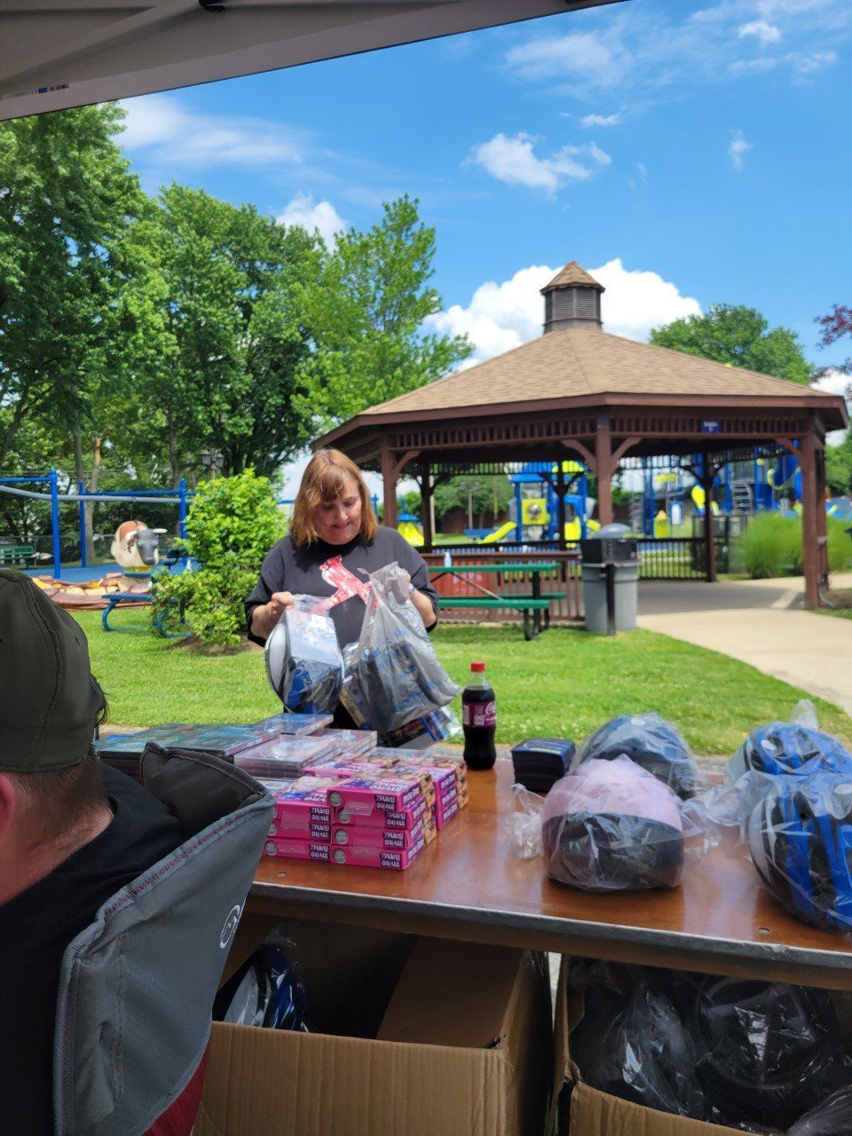 A man and a woman are sitting at a table in front of a gazebo.