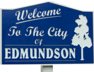 A blue sign that says welcome to the city of edmundson