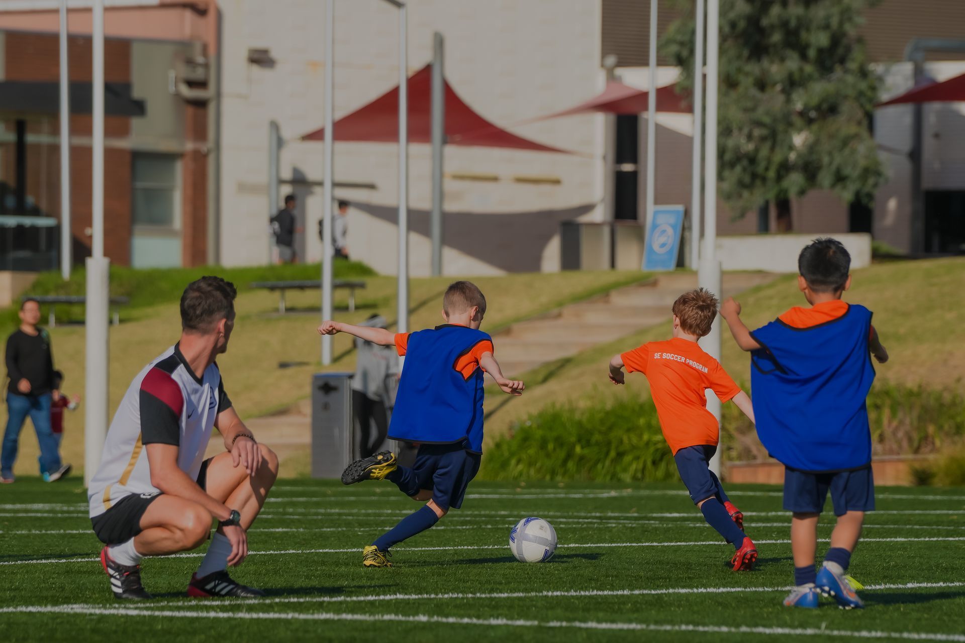 A group of young boys are playing soccer on a field.