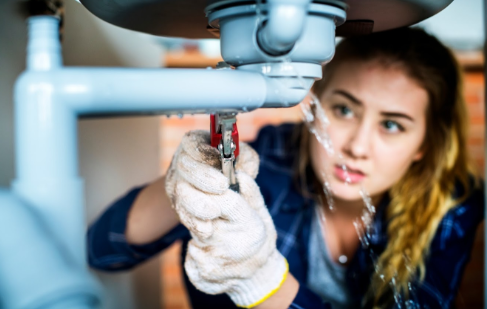 Water Softeners — Woman Fixing the Pipe in Dayton, OH