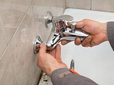 Plumber Works in a Bathroom — Plumbing Service in Dayton, OH