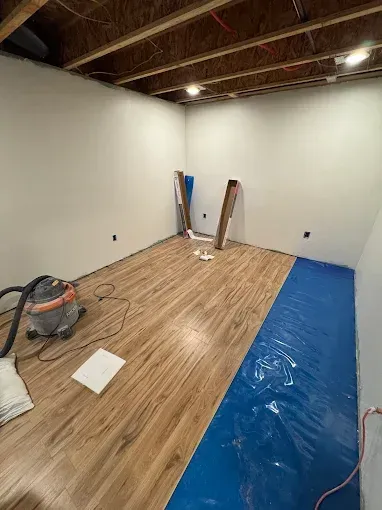 A room with hardwood floors and a vacuum cleaner in it.
