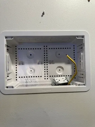A white box with a yellow wire coming out of it