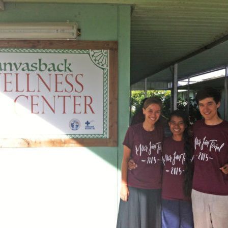 Three people standing in front of a sign that says canvasback wellness center