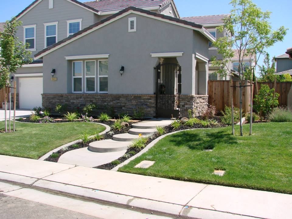 A house with a concrete walkway leading to the front door