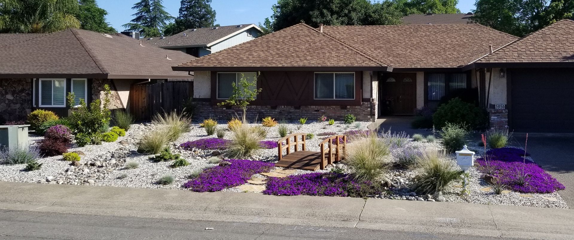 A house with a lot of flowers in front of it