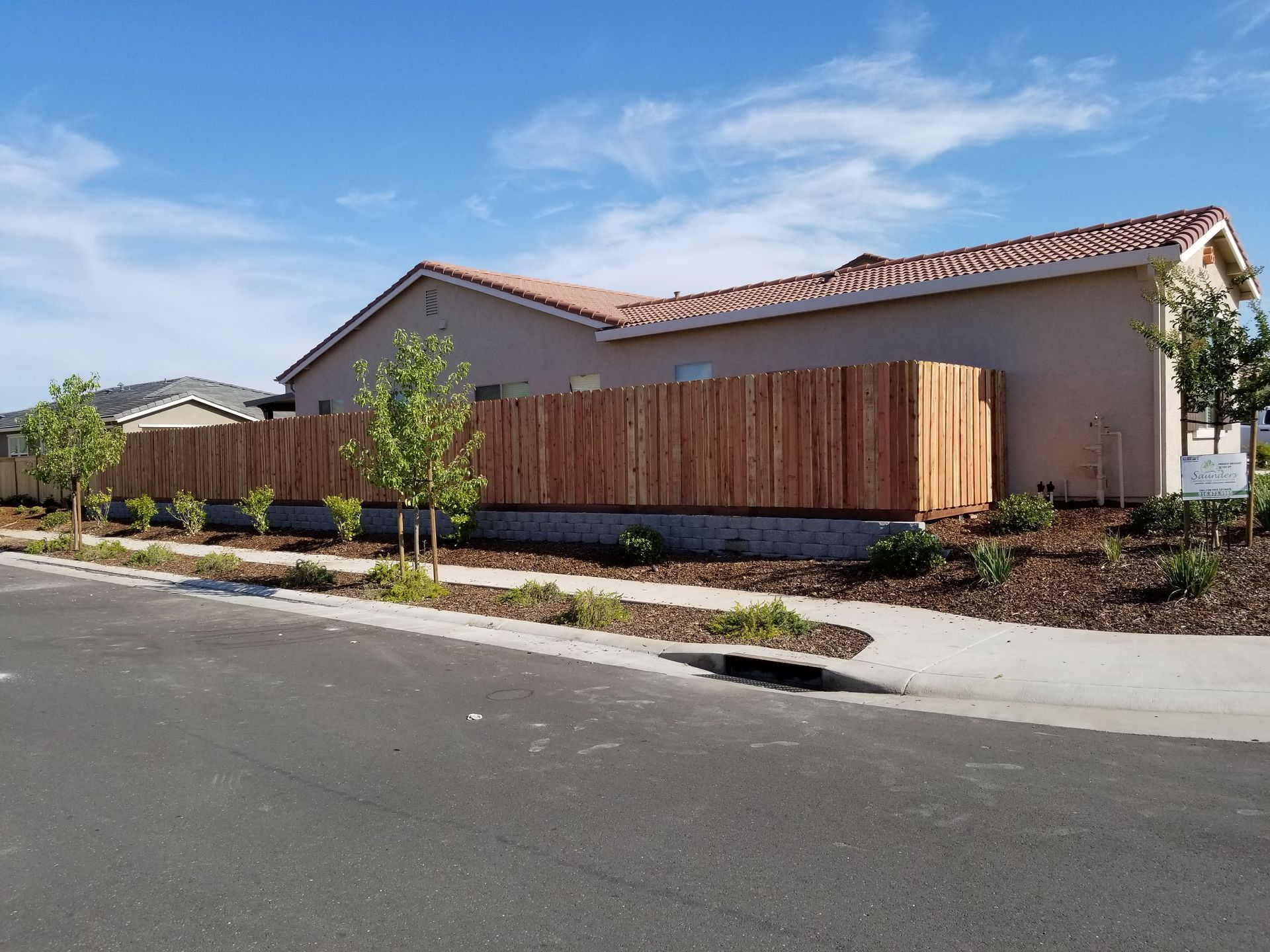 A house with a wooden fence in front of it