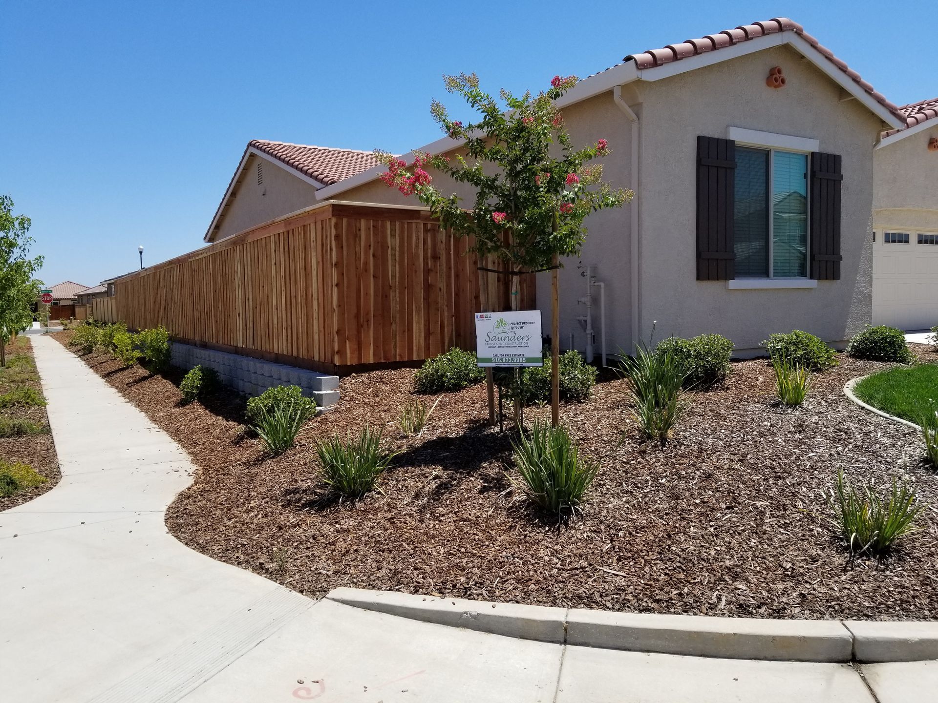 A house with a wooden fence and a sign that says 