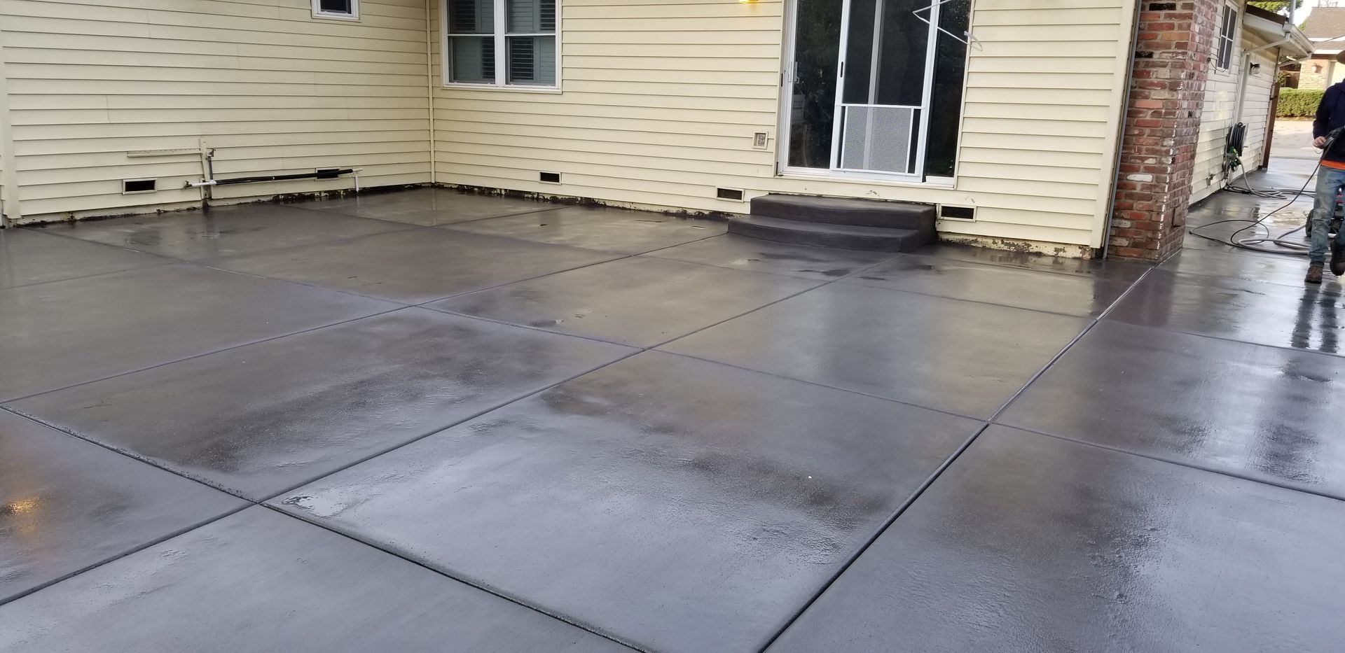A large concrete patio in front of a house.