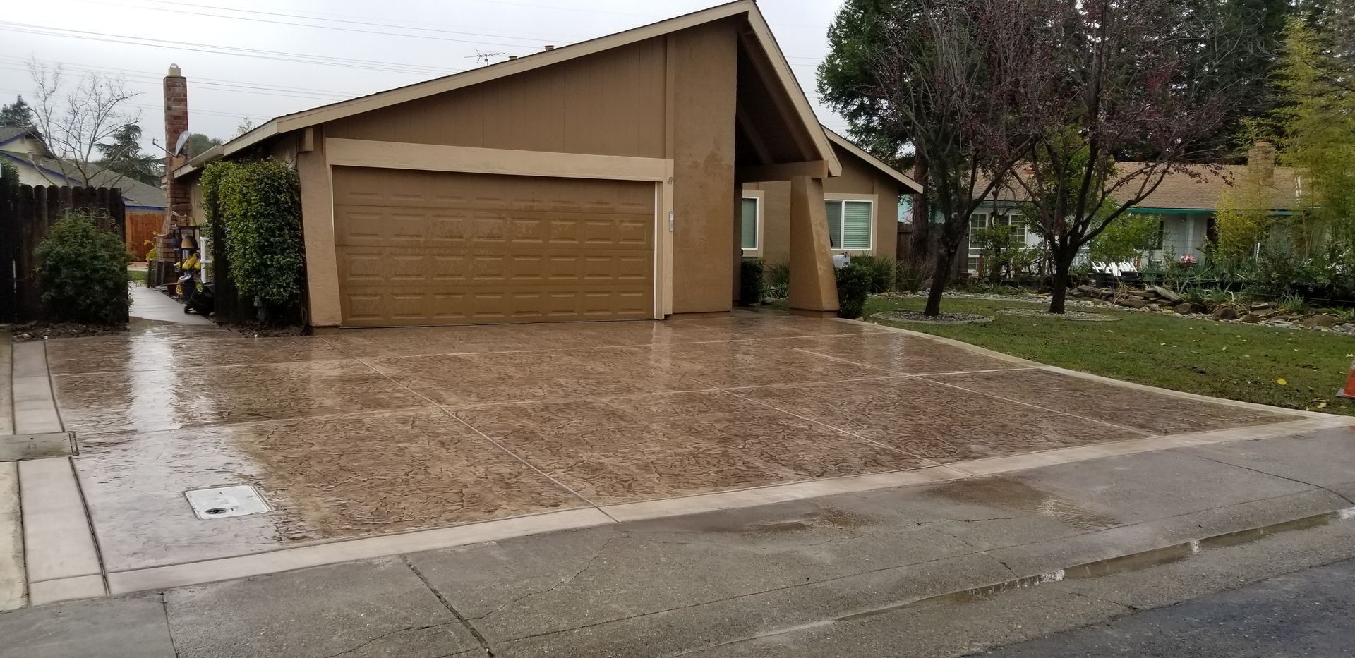A house with a garage and a driveway in front of it.