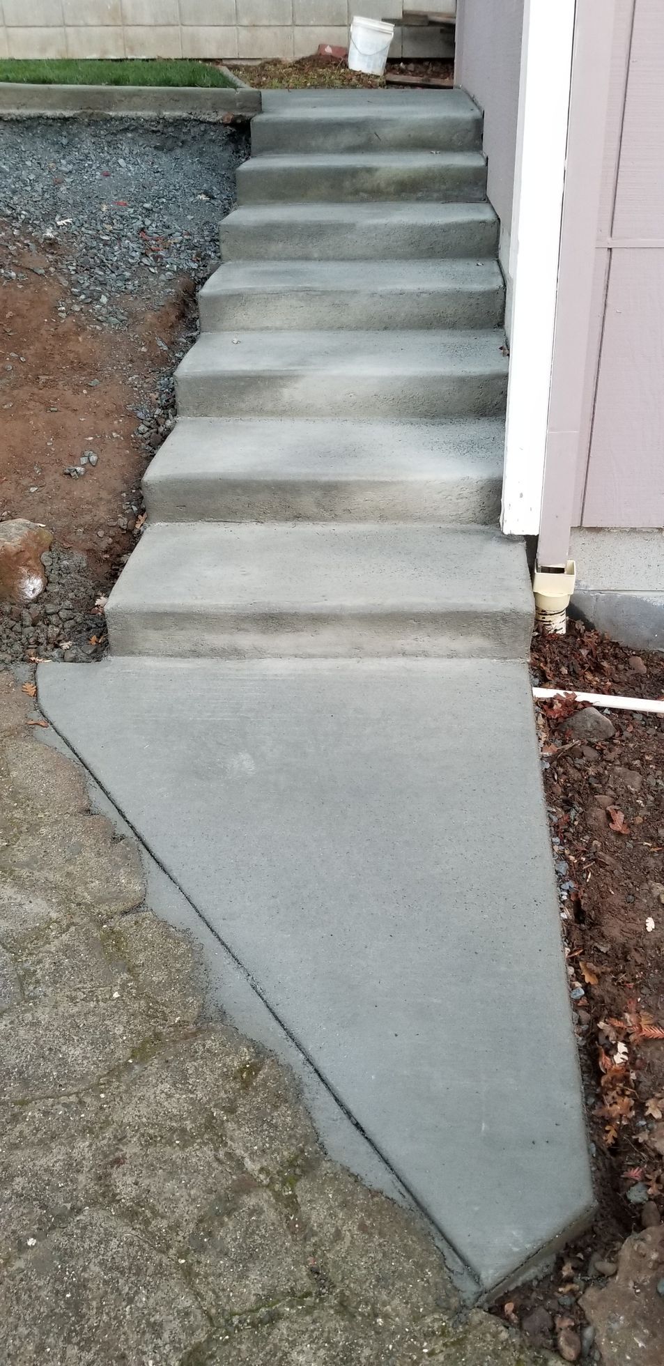 A set of concrete steps leading up to a house.
