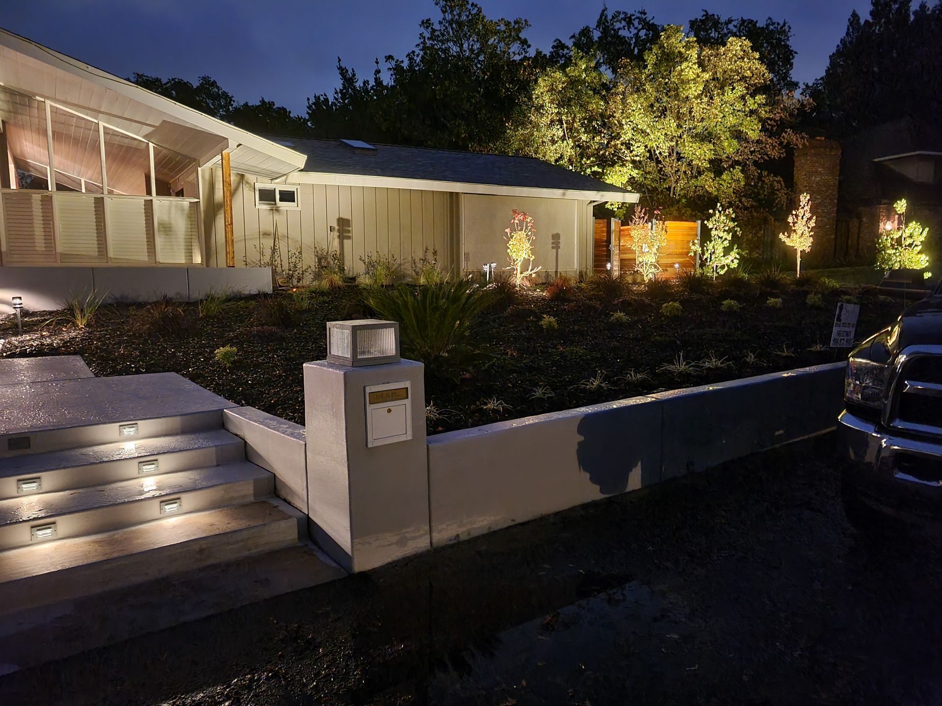 The front of a house is lit up at night