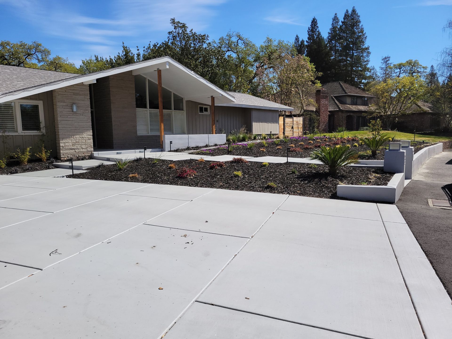 A house with a concrete driveway in front of it