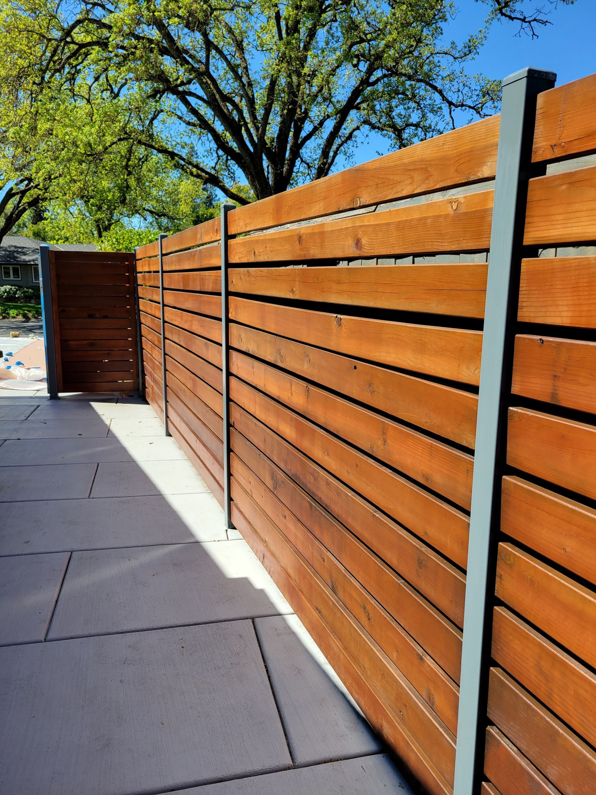 A wooden fence with a tree in the background
