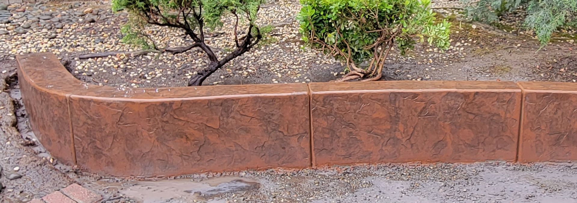 A brick wall with a tree in the background