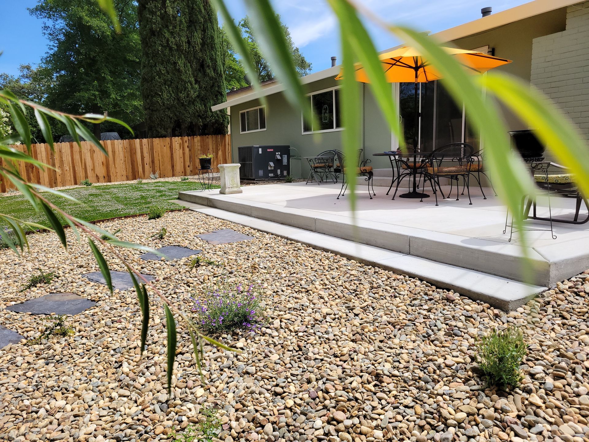 A house with a patio and umbrella in the backyard
