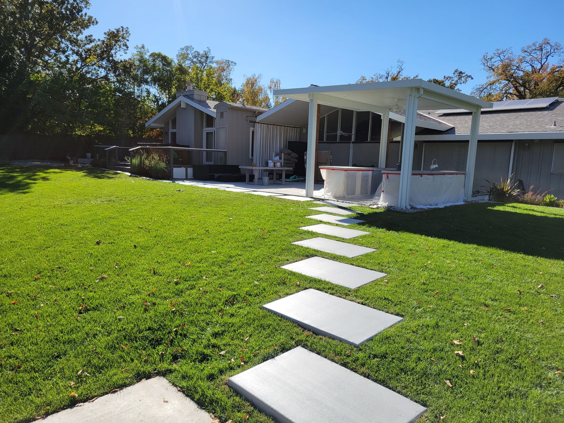 A house with a covered patio and a walkway leading to it
