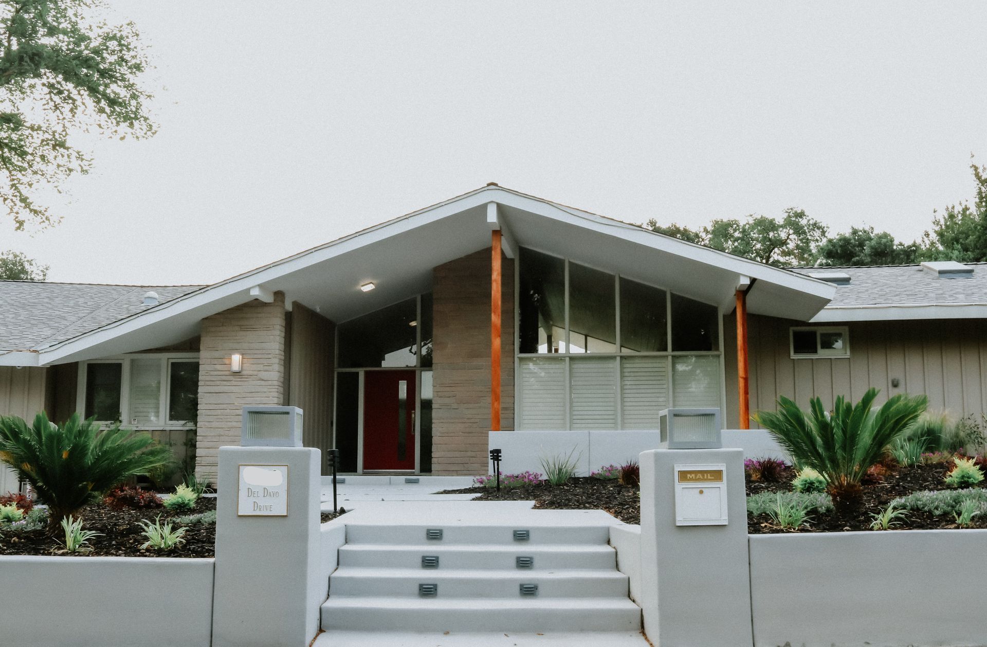 A house with a red door and stairs is for sale.