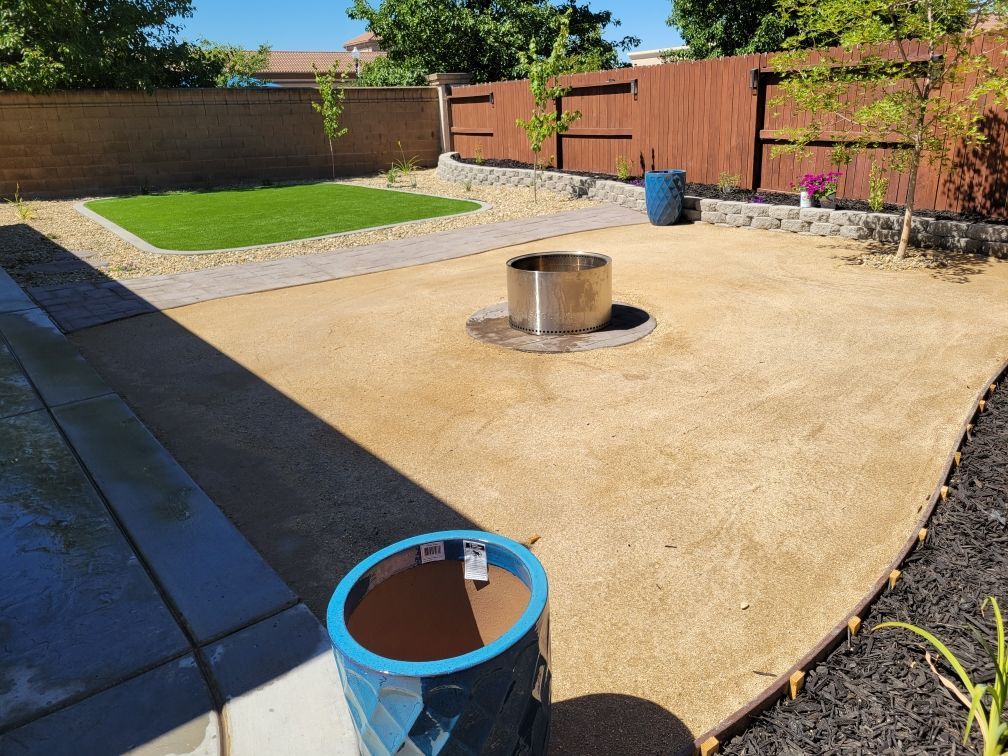 There is a fire pit in the middle of the backyard.