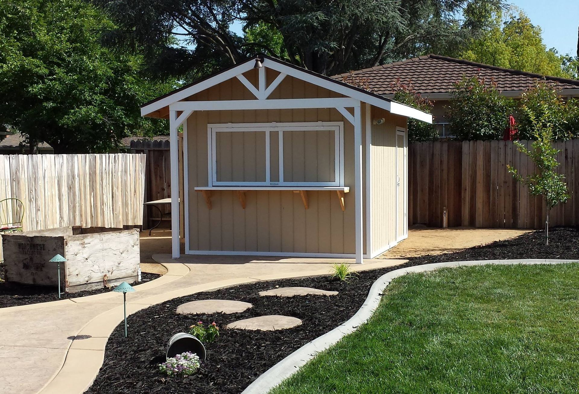 A small shed in the backyard of a house