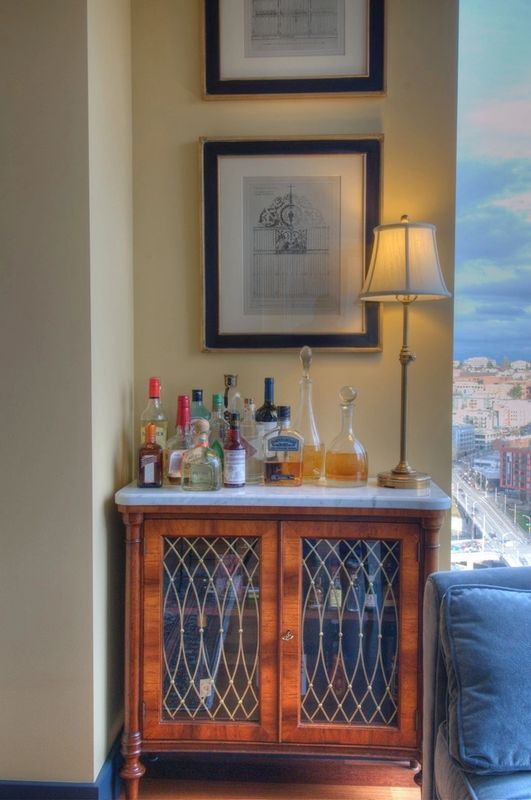 A wooden cabinet with bottles of liquor on it
