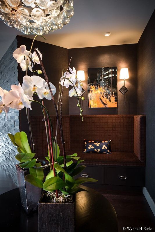 A room with a couch and a vase of flowers