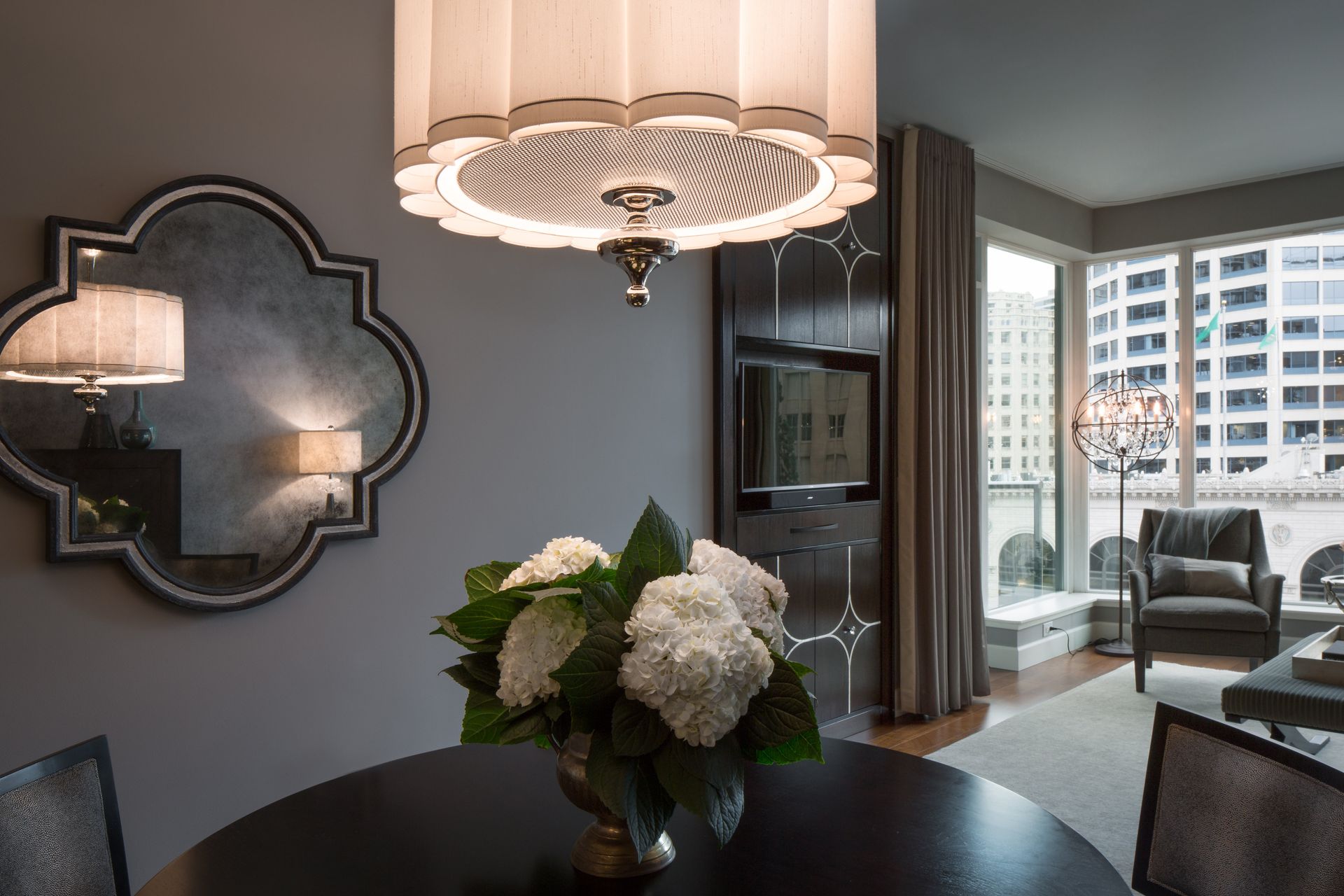 A dining room table with a vase of flowers on it