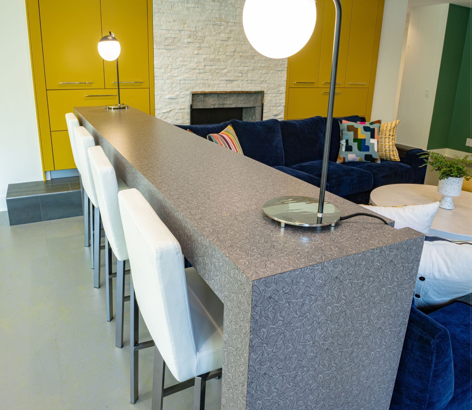 A living room with a blue couch and a long counter