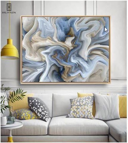 A living room with a couch and a painting on the wall.