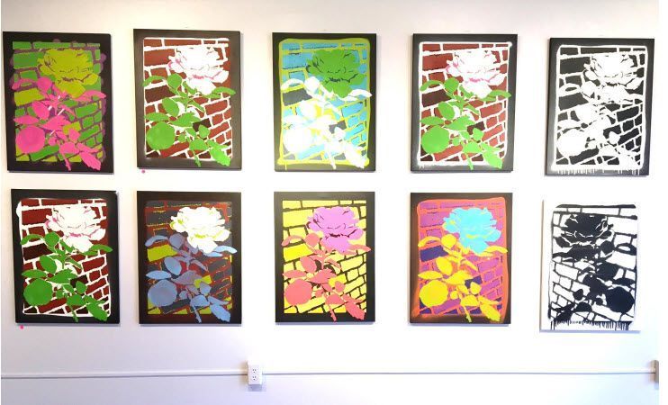 A wall with a bunch of paintings on it