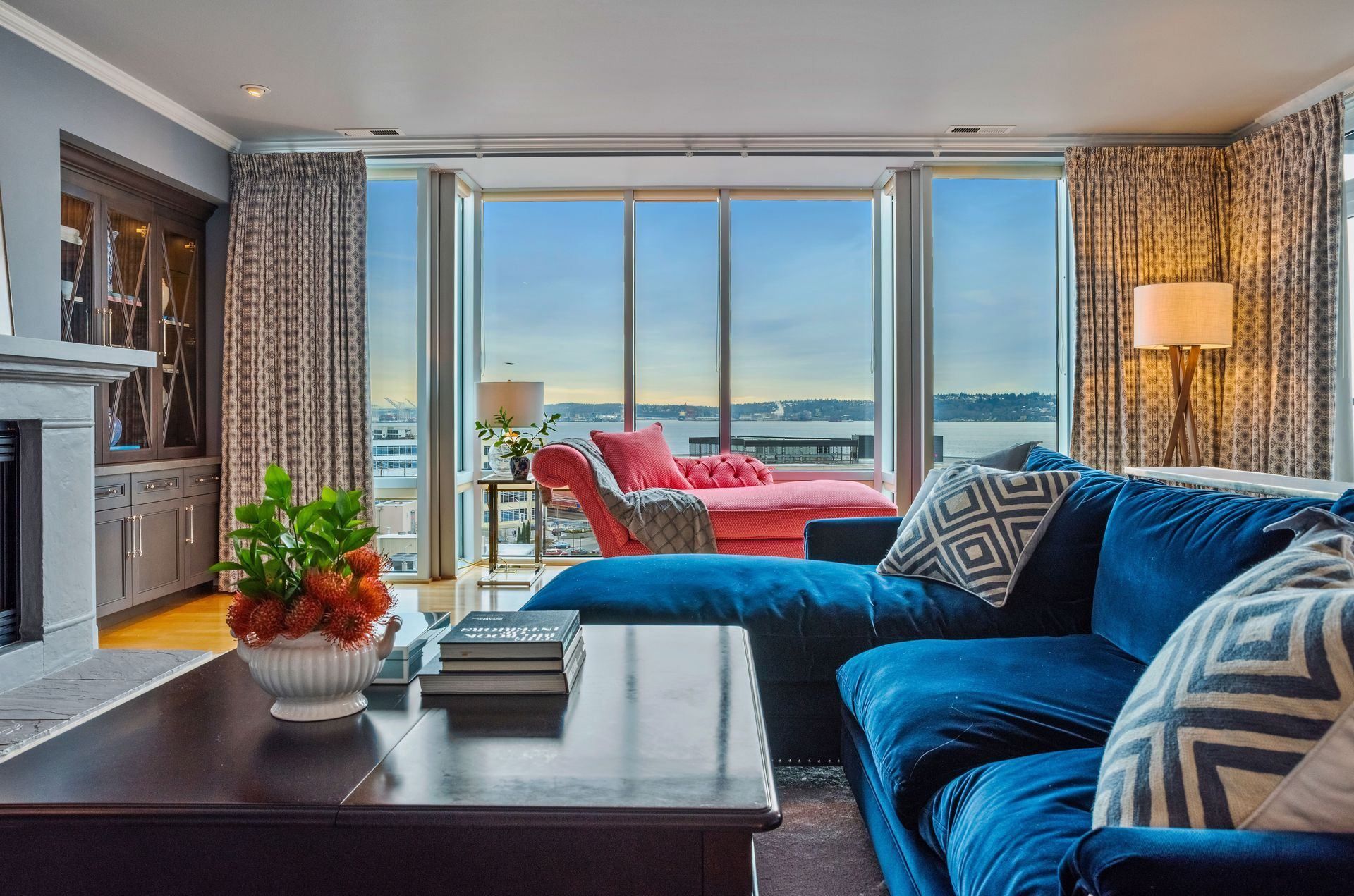 A living room with a blue couch and a coffee table