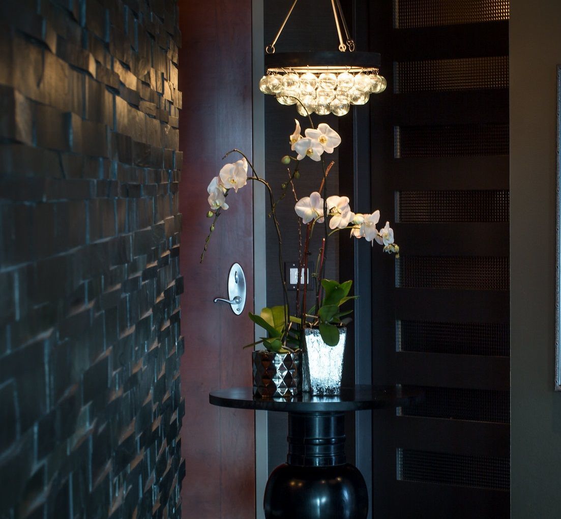 A vase of flowers sits on a table in a hallway