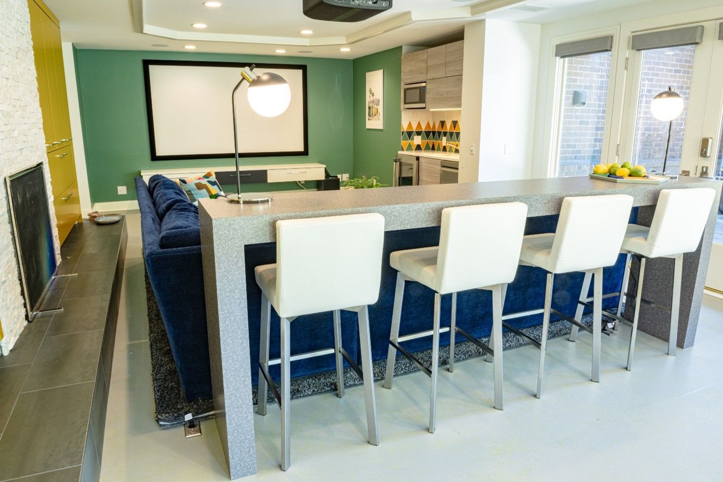A living room with a bar and a projector screen