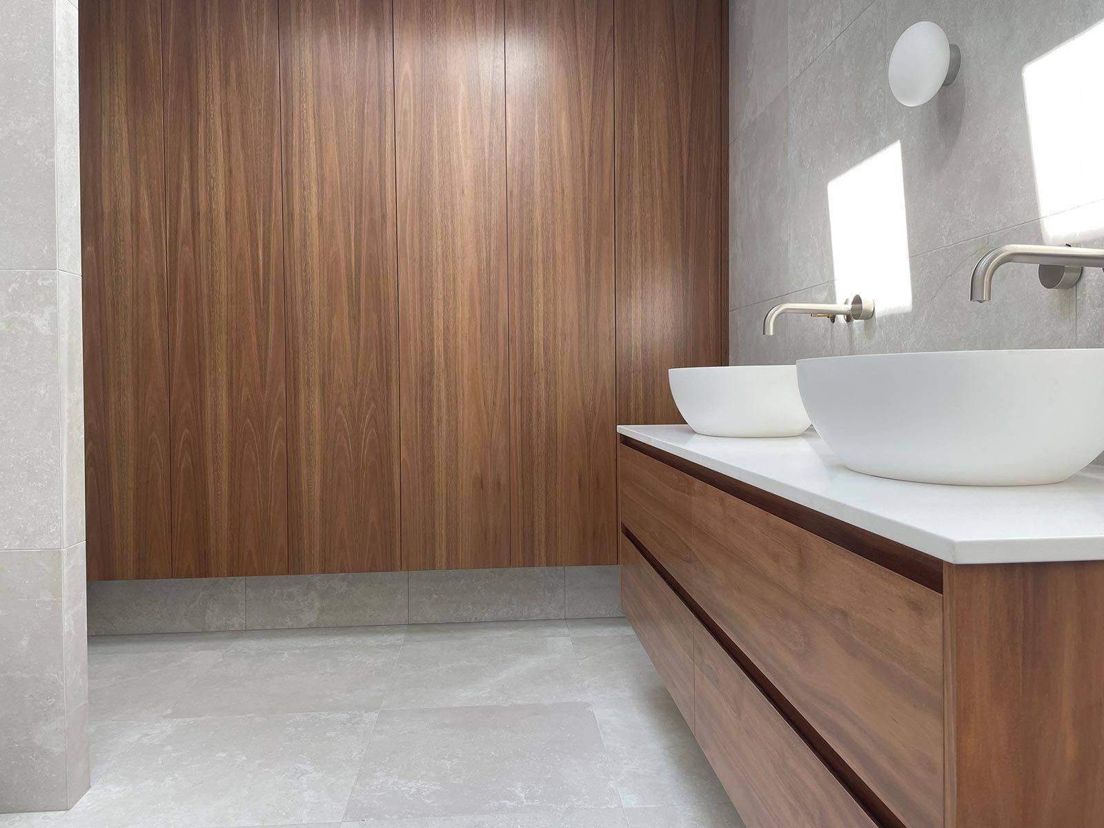 A Bathroom With Two Sinks And A Wooden Wall — Ben Lynch Cabinetmaking in South Lismore, NSW
