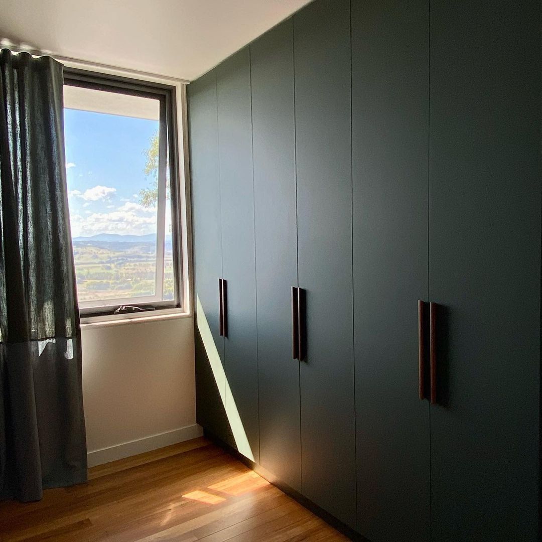 A Bedroom with A Large Window and Green Cabinets — Ben Lynch Cabinetmaking in South Lismore, NSW