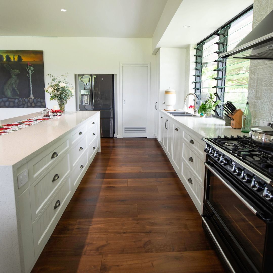 A Kitchen with White Cabinets and A Black Stove — Ben Lynch Cabinetmaking in South Lismore, NSW